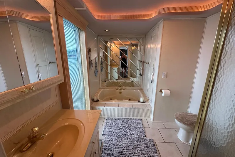 Slide: The Image of Luxurious bathroom with mirrored jacuzzi, elegant lighting, and modern fixtures in a 2001 Fantasy 18x82. - 14