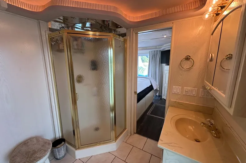 Slide: The Image of Luxurious bathroom in 2001 Fantasy 18x82 houseboat with gold-accented shower and elegant vanity. - 15