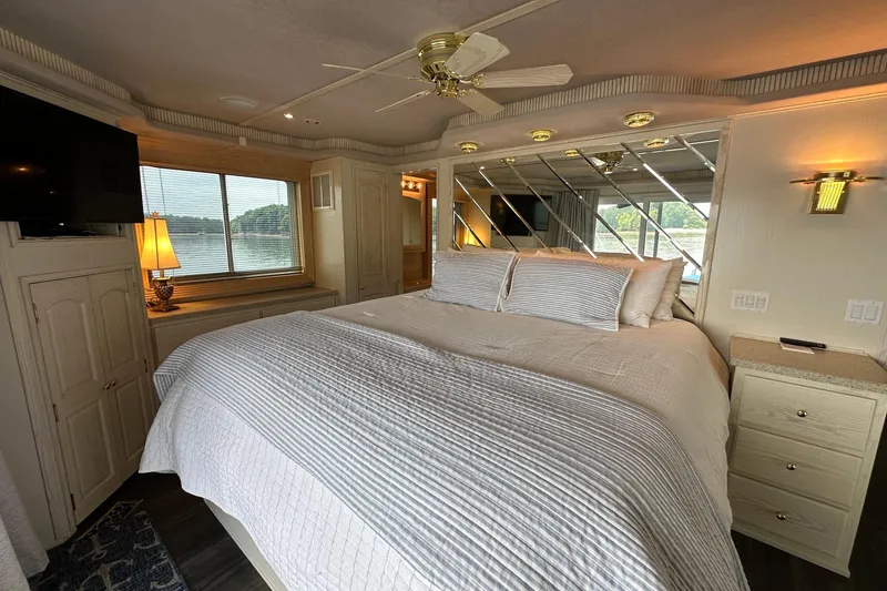 Slide: The Image of Luxurious bedroom in a 2001 Fantasy 18x82 houseboat with elegant decor and scenic window view. - 17