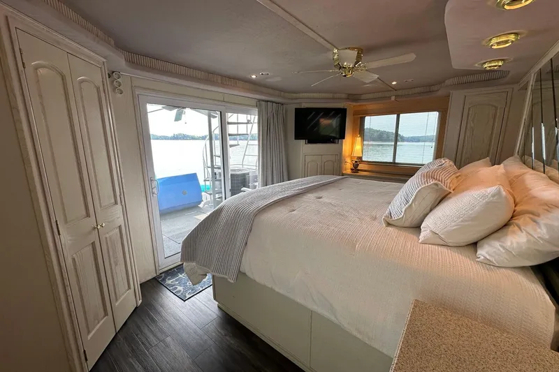 Slide: The Image of Luxurious bedroom in 2001 Fantasy 18x82 houseboat with lake view and modern amenities. - 18