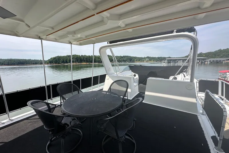 Slide: The Image of Covered deck of 2001 Fantasy 18x82 houseboat with lake view and outdoor seating. - 21
