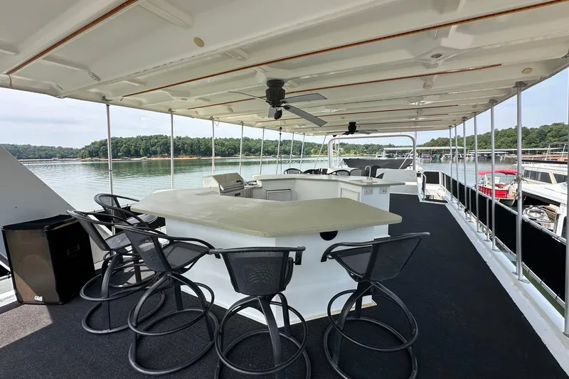 Slide: The Image of Upper deck of 2001 Fantasy 18x82 houseboat with bar seating, overlooking serene lake. - 22