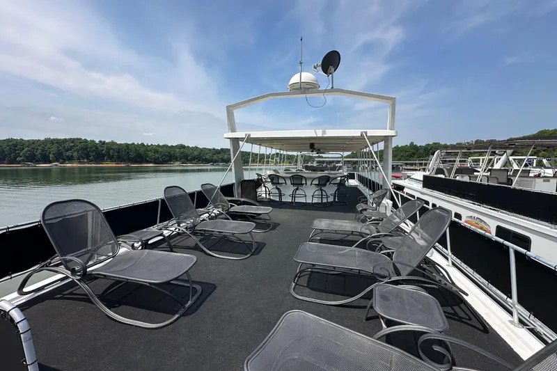Slide: The Image of Upper deck of a 2001 Fantasy 18x82 houseboat with lounge chairs and scenic lake view. - 23