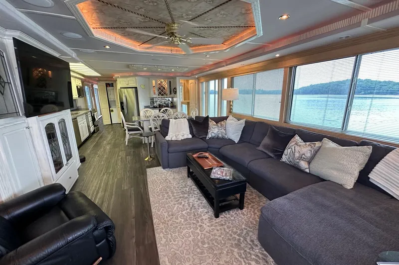 Slide: The Image of Luxurious houseboat interior with modern kitchen, spacious seating, and scenic water views. Fantasy 18x82, 2001. - 4