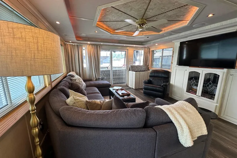 Slide: The Image of Luxurious living room in a 2001 Fantasy 18x82 houseboat with plush seating and modern decor. - 5
