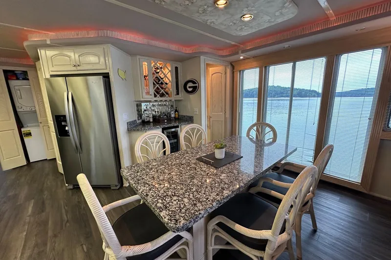 Slide: The Image of Luxurious houseboat kitchen with granite countertops, modern appliances, and scenic lake view. Fantasy 18x82, 2001. - 8