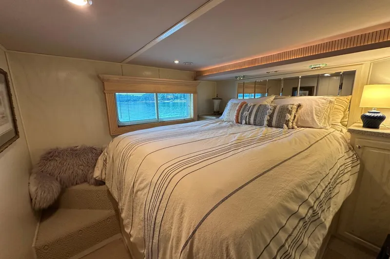 Slide: The Image of Luxurious bedroom interior in a 2001 Fantasy 18x82 houseboat with cozy bedding and ambient lighting. - 9