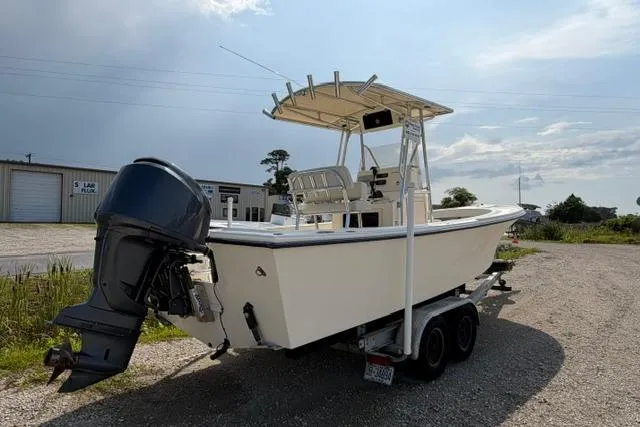 Slide: The Image of 2007 Parker 23 SE boat on trailer, featuring outboard motor and T-top, parked outdoors. - 1