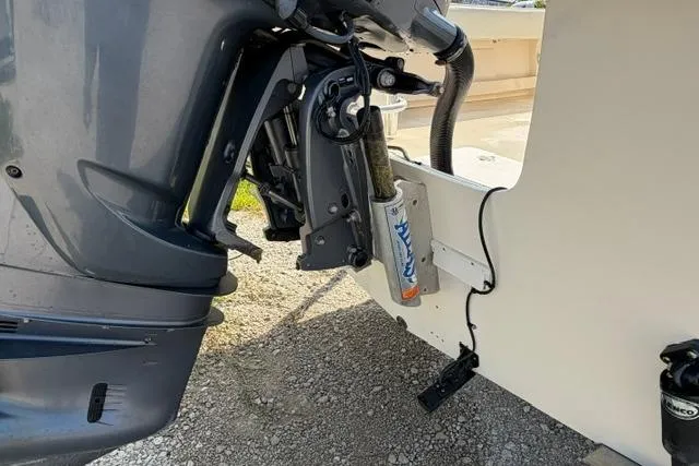 Slide: The Image of 2007 Parker 23 SE boat motor and hydraulic system on gravel surface. - 2