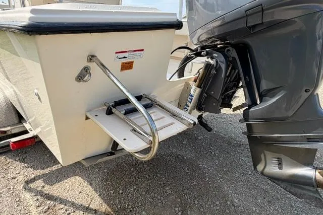 Slide: The Image of 2007 Parker 23 SE boat stern with ladder and outboard motor on gravel surface. - 4