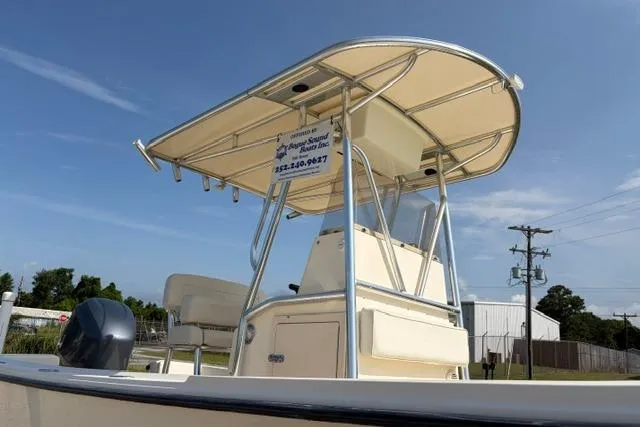 Slide: The Image of 2007 Parker 23 SE boat with canopy, viewed from the side under a clear blue sky. - 6