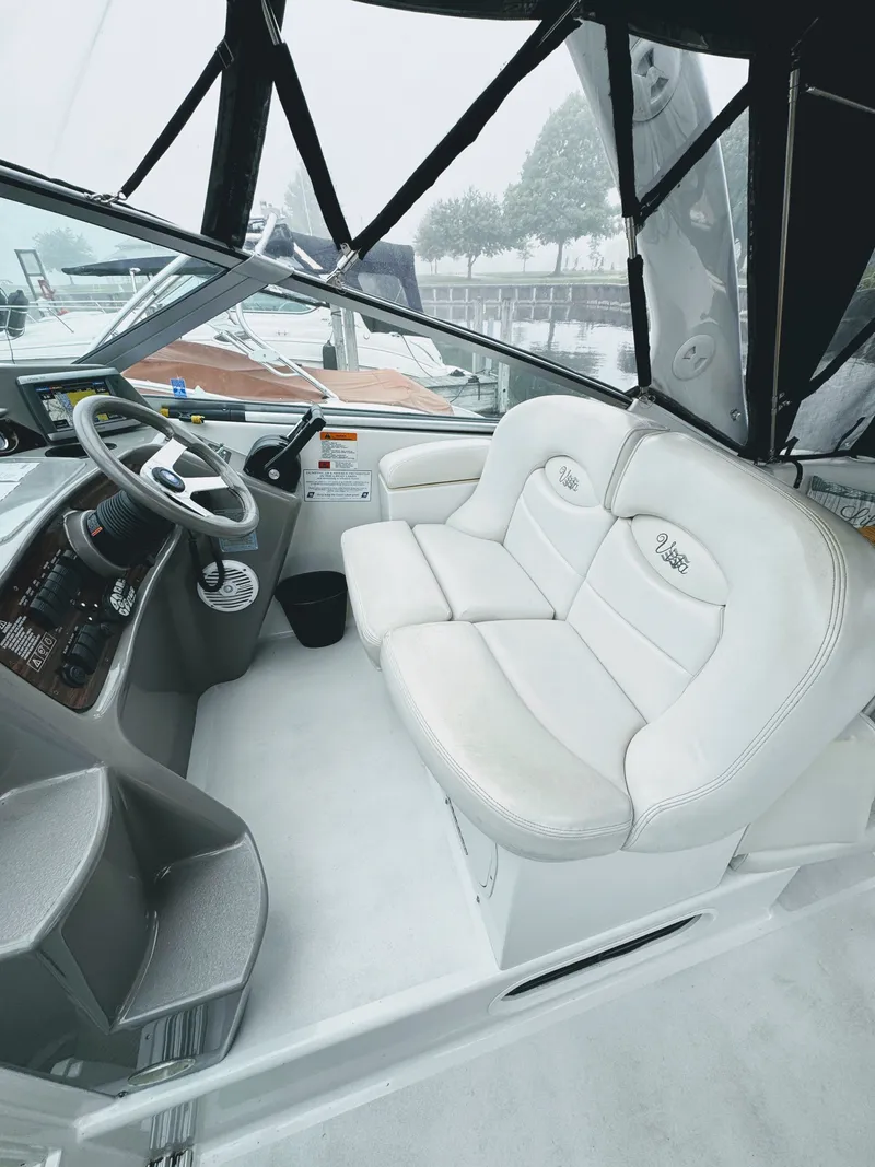 Slide: The Image of The image shows the cockpit of a 2001 Four Winns 298 Vista with white leather seats. - 10