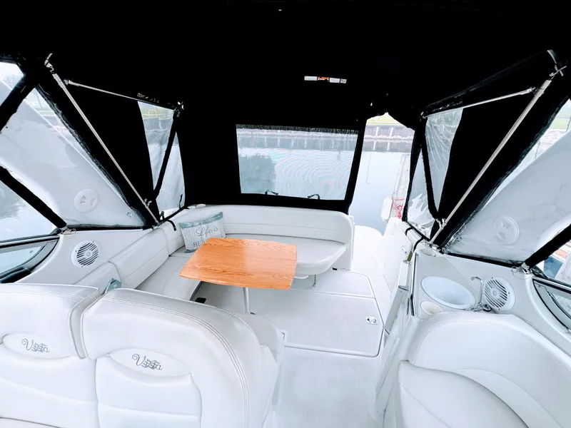 Slide: The Image of Interior of a 2001 Four Winns 298 Vista with white seating and a wooden table. - 11