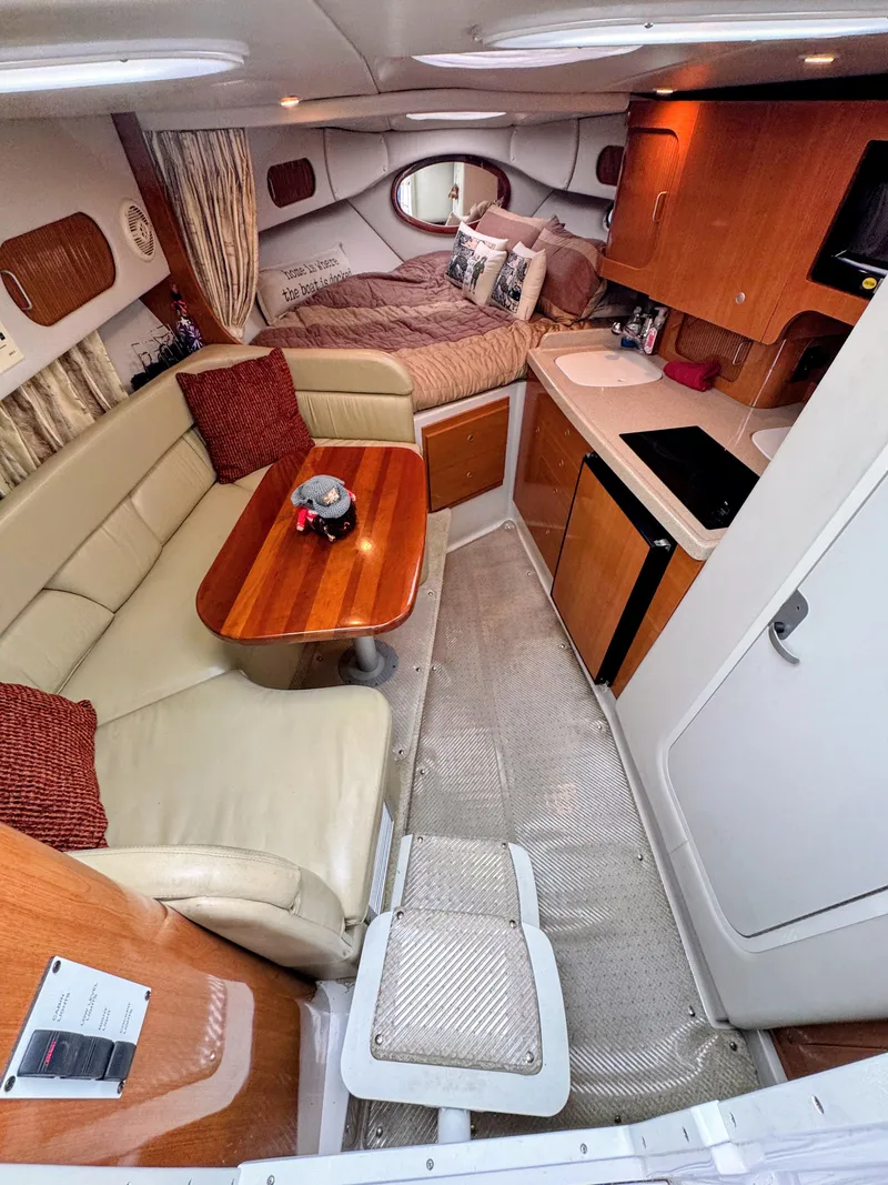 Slide: The Image of Interior of the 2001 Four Winns 298 Vista with cozy seating area and kitchenette. - 16