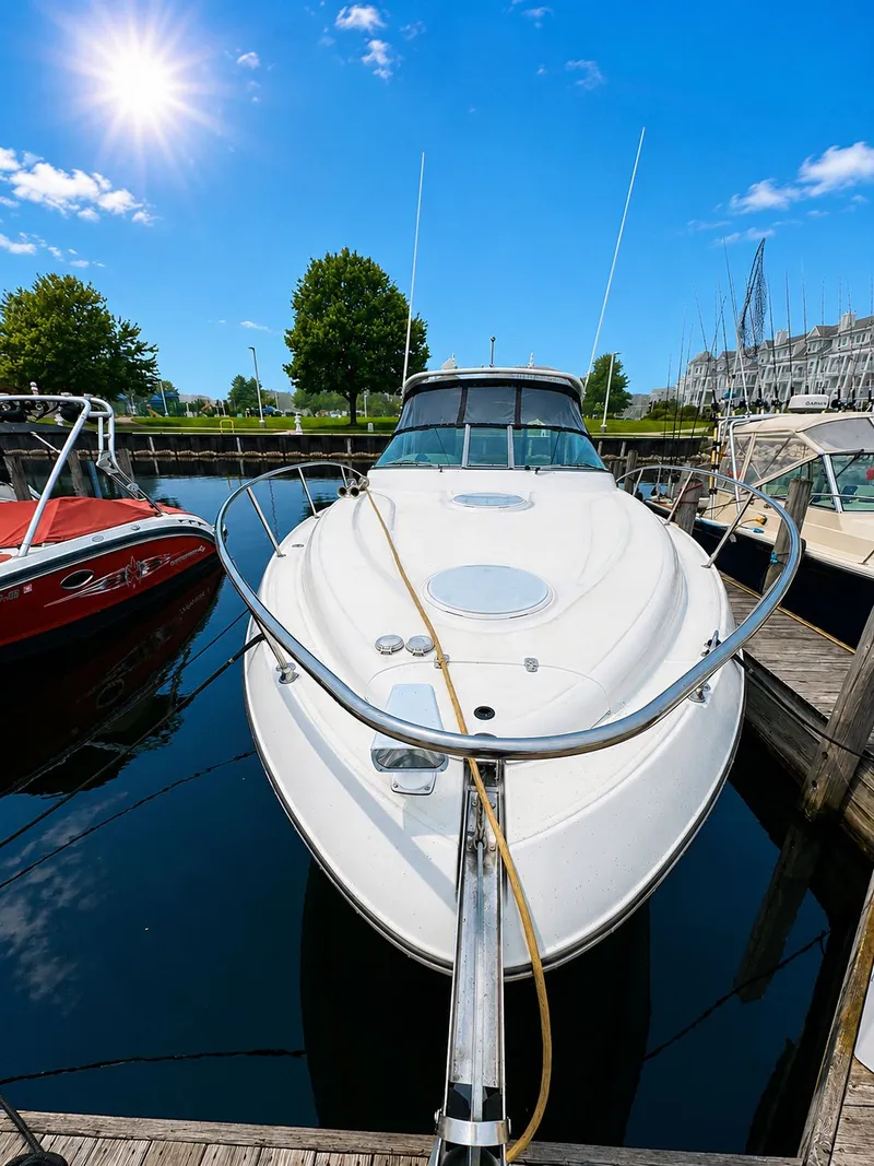 Slide: The Image of A 2001 Four Winns 298 Vista docked on a sunny day in the harbor. - 2
