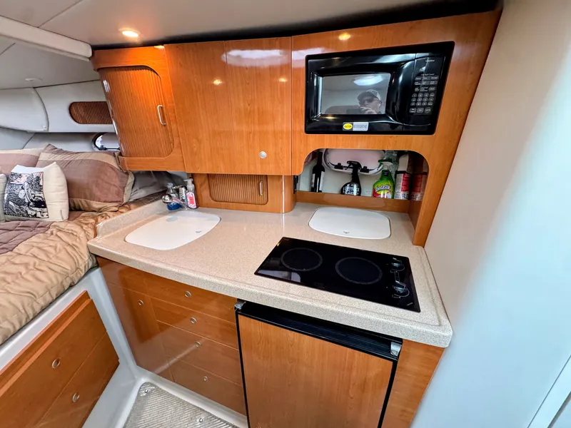Slide: The Image of Interior of the 2001 Four Winns 298 Vista with kitchenette, microwave, and sleeping area. - 20