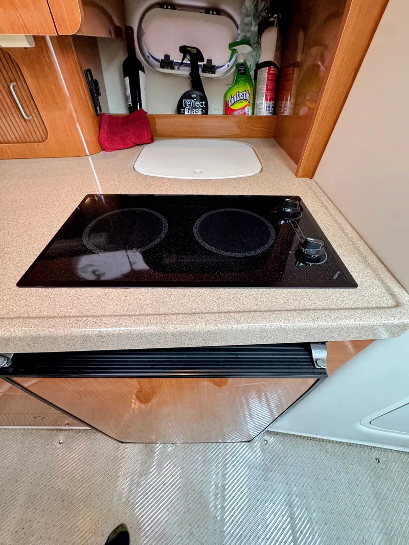 Slide: The Image of Galley area with stove and cabinets in a boat. - 21