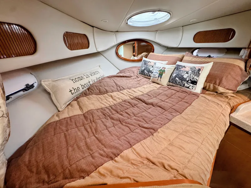 Slide: The Image of Cozy cabin with a large bed, decorative pillows, and wood paneling. - 22