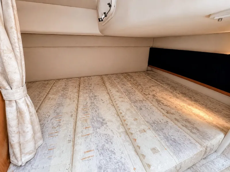 Slide: The Image of Interior of a 2001 Four Winns 298 Vista with a large, cushioned sleeping area. - 23