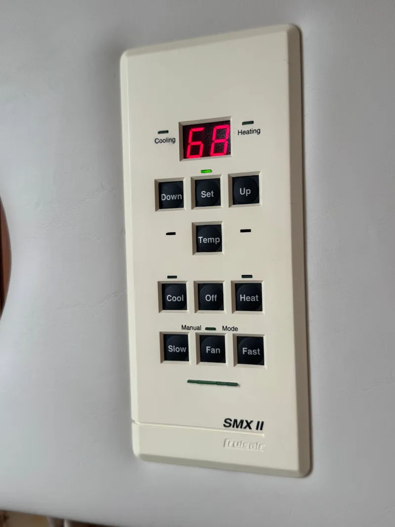 Slide: The Image of Air conditioning control on a boat with temperature display and various settings. - 27