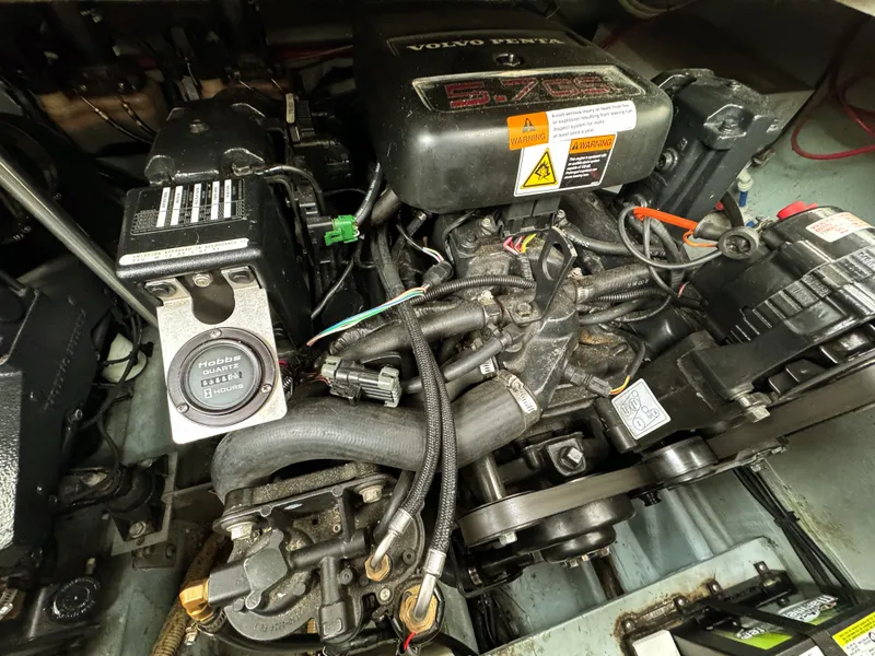 Slide: The Image of Close-up of a Volvo Penta engine in a boat, surrounded by cables and hoses. - 29