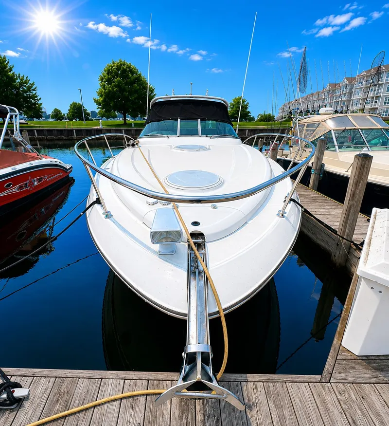 Slide: The Image of A white motor yacht docked in a sunny marina, surrounded by other boats and buildings. - 3