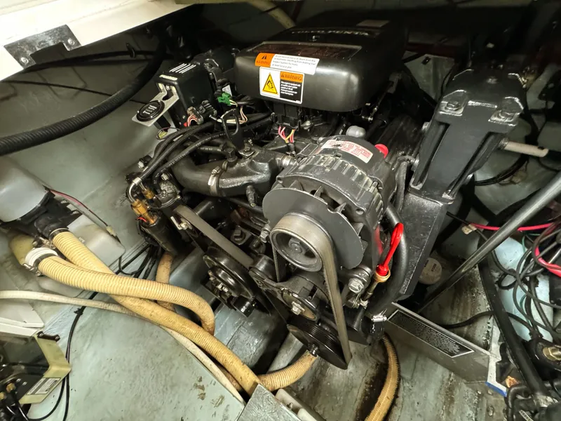 Slide: The Image of An engine compartment with a well-maintained engine and hoses. - 30