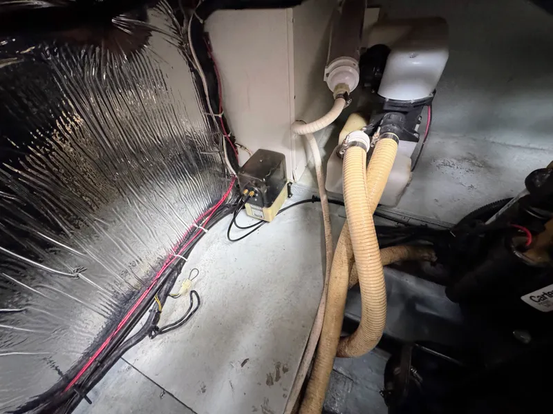 Slide: The Image of Interior view of a boat engine compartment with hoses and wiring. - 32