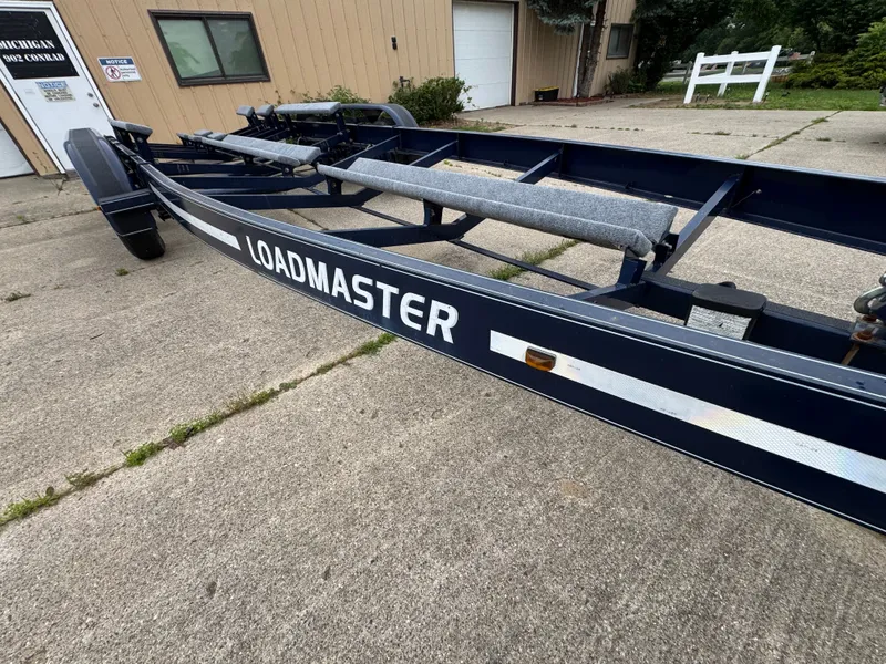 Slide: The Image of Boat trailer on a concrete surface in front of a building. - 39