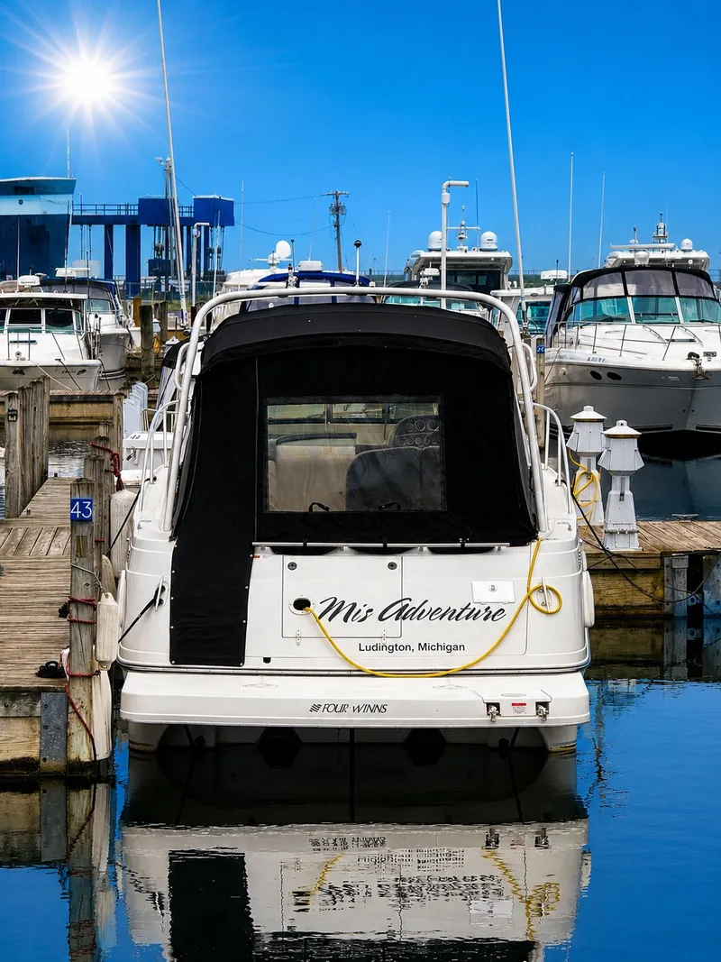 Slide: The Image of A 2001 Four Winns 298 Vista docked in a marina, surrounded by other boats. - 4