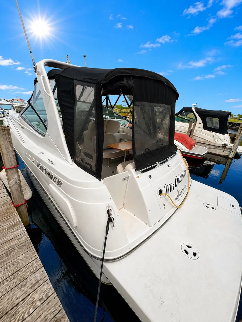 Slide: The Image of A white motor yacht docked at a wooden pier, featuring a black canopy under a blue sky. - 5