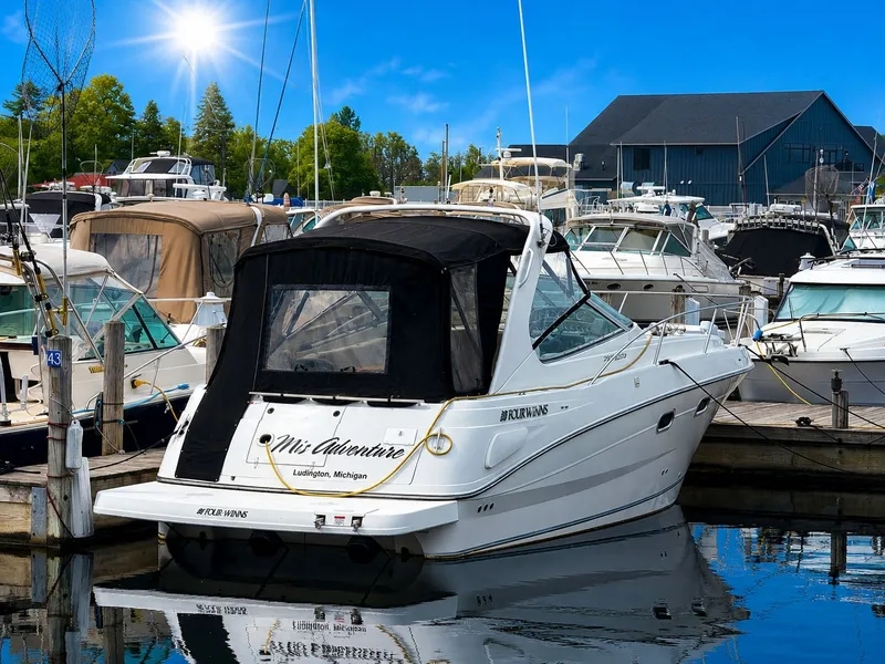 Slide: The Image of A white motor yacht docked in a calm marina, surrounded by other boats. - 6