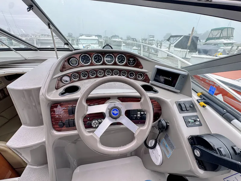Slide: The Image of The cockpit of a 2001 Four Winns 298 Vista with a sleek dashboard and Garmin navigation system. - 7