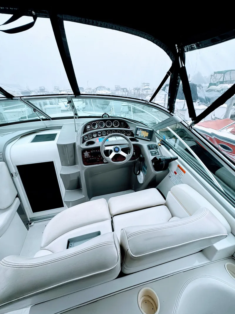 Slide: The Image of The cockpit of a 2001 Four Winns 298 Vista with white upholstery and a modern dashboard. - 8