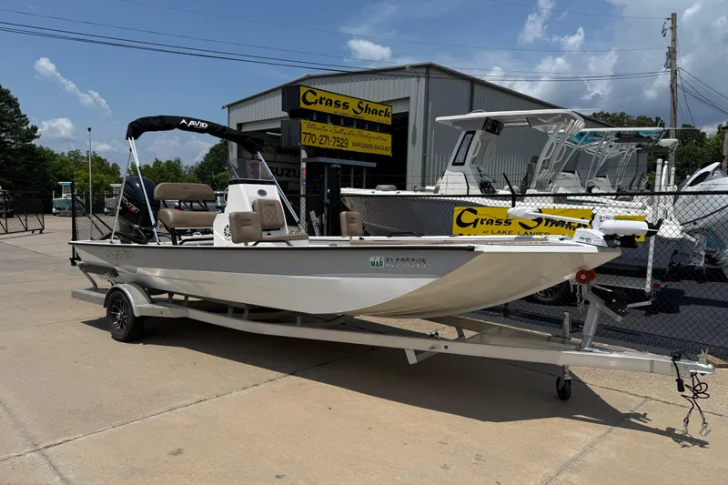 The Image of 2025 Avid 22 Recon boat on trailer at dealership, sunny day. - 8