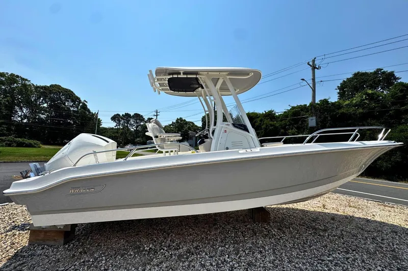 The Image of 2026 Boston Whaler 220 Dauntless boat displayed outdoors on gravel. - 0