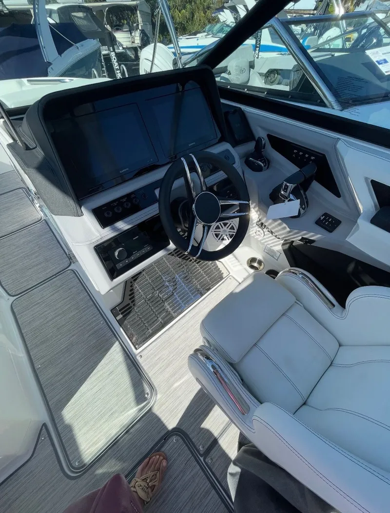Slide: The Image of The cockpit of a modern yacht with a sleek steering wheel and digital displays. - 2