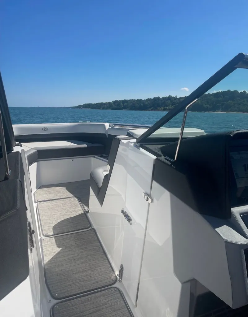 Slide: The Image of The image shows the deck of a Cobalt R8 boat on the water with a view of the shoreline. - 4