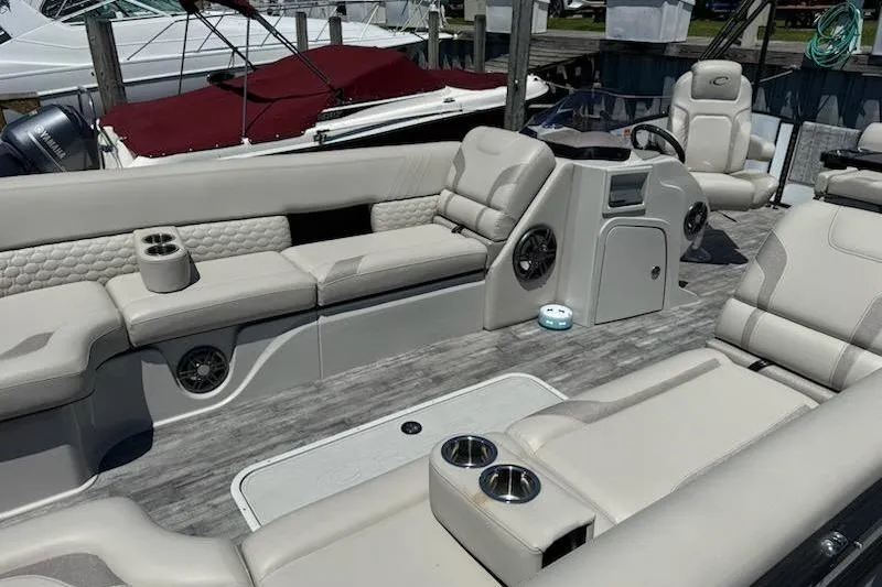 Slide: The Image of Luxurious interior of 2021 Crest Caribbean LX 250 SLS pontoon boat with plush seating and cup holders. - 4