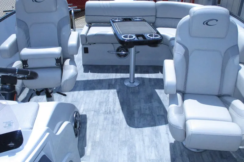 Slide: The Image of Interior of 2021 Crest Caribbean LX 250 SLS pontoon boat with plush seating and table. - 11