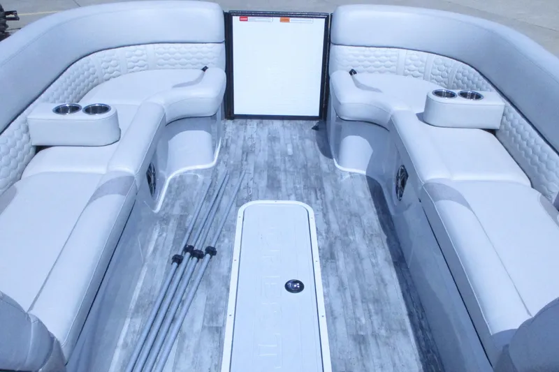 Slide: The Image of Interior of 2021 Crest Caribbean LX 250 SLS pontoon boat with luxurious seating and cup holders. - 12