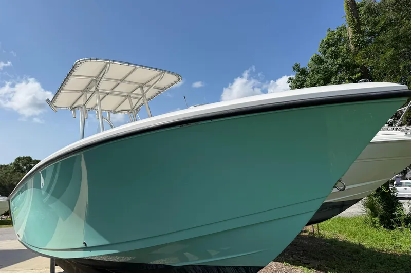 The Image of 2023 Aquasport 2200 Center Console boat with sleek design, displayed outdoors. - 1