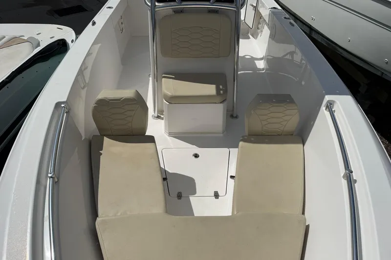 Slide: The Image of 2023 Aquasport 2200 Center Console boat interior with beige seating and white deck. - 10