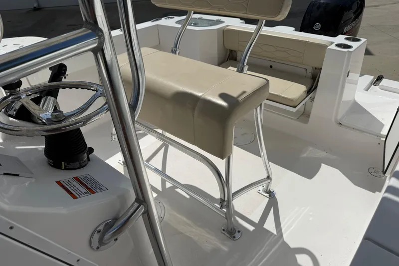 Slide: The Image of 2023 Aquasport 2200 Center Console boat interior with steering wheel and seating. - 12