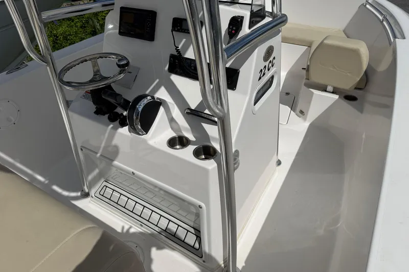 Slide: The Image of 2023 Aquasport 2200 Center Console boat interior with steering wheel and seating. - 7