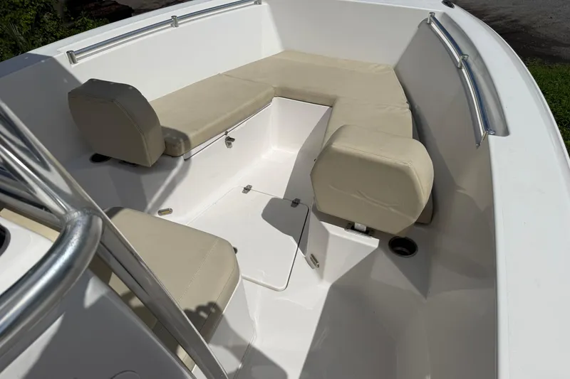 Slide: The Image of 2023 Aquasport 2200 Center Console boat interior with cushioned seating and storage. - 8
