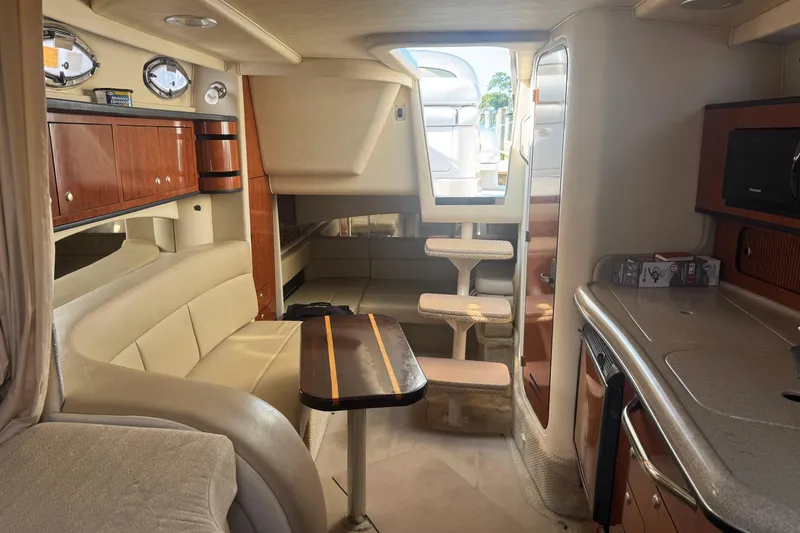 Slide: The Image of Interior of a 2006 Sea Ray 300 Sundancer yacht with seating and kitchenette. - 6