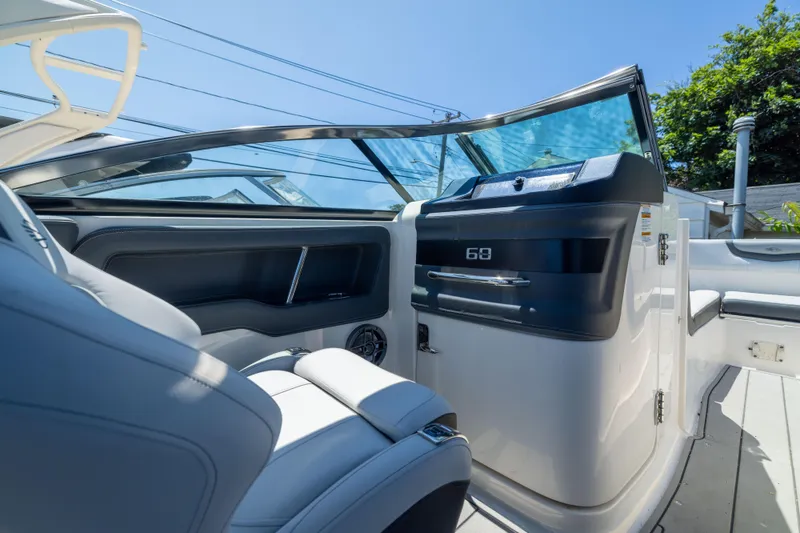 Slide: The Image of Interior view of 2025 Chaparral 250 OSX boat, featuring sleek seating and modern dashboard. - 11
