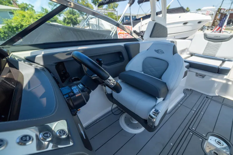 Slide: The Image of 2025 Chaparral 250 OSX boat interior with modern helm and luxurious seating. - 7