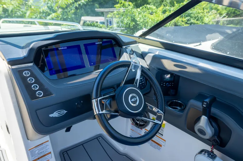 Slide: The Image of 2025 Chaparral 250 OSX boat dashboard with modern controls and dual Simrad displays. - 9